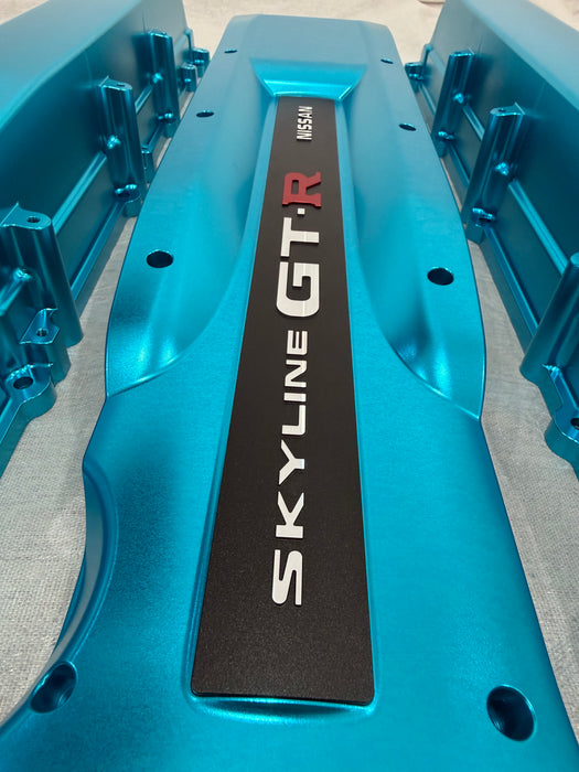 Blue engine cover with 'SKYLINE GT-R' branding on a gray background