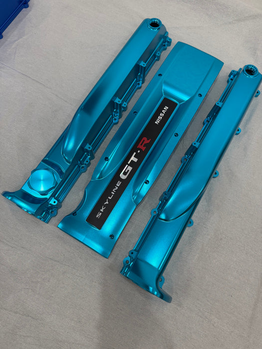 Blue car engine parts on a gray surface